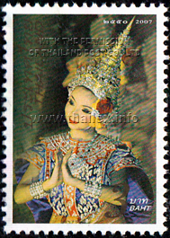 Female Thai dancer in a traditional brocade costume, wearing a chadah and making a wai gesture