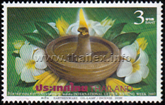 earthen oil lamp and some Fangipani and Michelia flowers