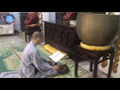 Buddhist Monk Chanting and Beating Wooden Fish